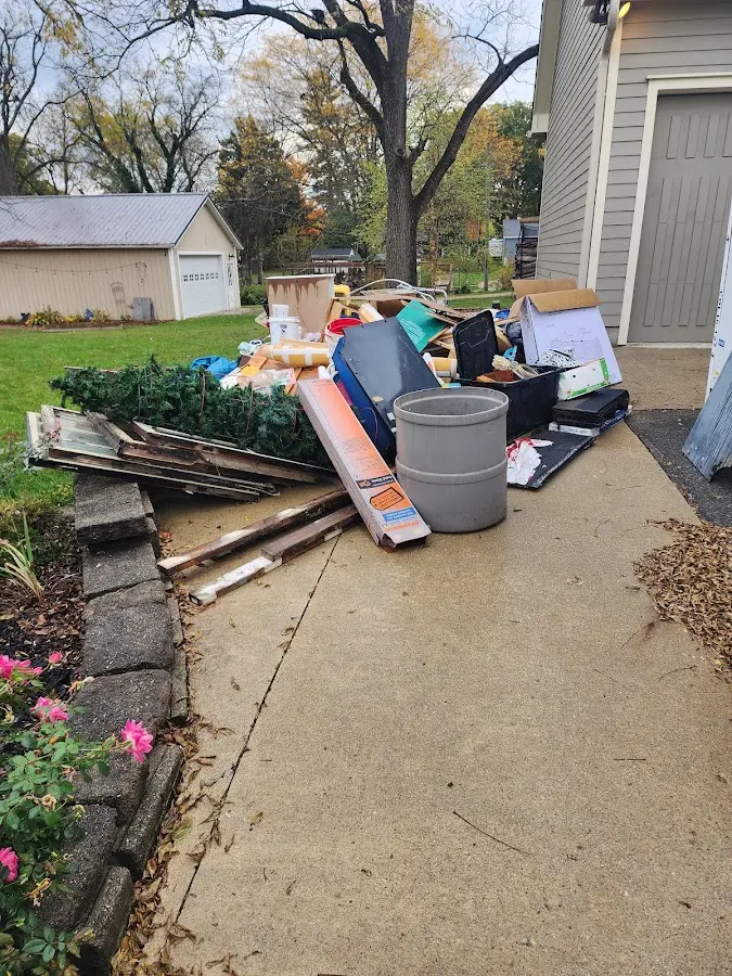 Dumpster being loaded with debris for Commercial Dumpster Rental in Fairmont